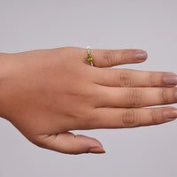 Hand wearing a ring with a green gemstone on a gray background, Non Traditional Engagement Ring, East West Marquise Cut Gemstone Ring, August Birthstone Peridot Ring, Affordable Three Stone Engagement Ring
