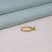 Gold ring with a green gemstone on a light gray surface, bold color engagement ring, dainty green ring, birthstone ring for August, east west gemstone ring, alternative bridal ring, peridot and CZ ring