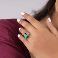 Hand wearing a green emerald ring with a white background, Statement CZ Gemstone Ring, Emerald Cut Three Stone Ring, Green Cubic Zirconia Ring for Her, Green Cubic Zirconia Ring for Her
