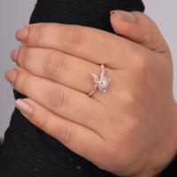 Hand wearing a diamond ring with a gray background, Unique Moissanite Animal Ring – Rose Gold Fox Design for Nature Lovers