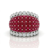 Ring with red gemstones and diamond accents on a white background