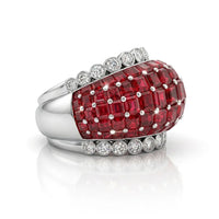 Ring with red gemstones and diamond accents on a white background