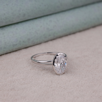 Silver ring with a large diamond on a beige surface, Bezel Set Split Shank Bridal Jewelry, Affordable Oval Wedding Anniversary Ring, Stylish Oval Bezel Engagement Ring