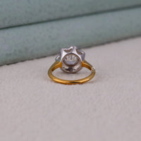 Two-tone ring with gold band and silver top on a light gray surface.