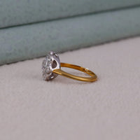 Two gold and silver rings on a light gray surface with a blurred background