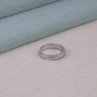 Silver ring with embedded stones on a soft surface,  bridal Moissanite band, minimalist Moissanite jewelry, durable wedding band, Moissanite stacking ring, elegant Moissanite ring, affordable diamond alternative, double band Moissanite ring, timeless Moissanite wedding ring