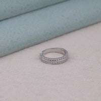 Silver ring with gemstones on a light skin surface, white gold Moissanite band, yellow gold Moissanite ring, rose gold Moissanite wedding band, two row Moissanite ring, half eternity wedding band, sparkling bridal band, Moissanite fine jewelry, luxury Moissanite ring