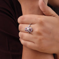 Close-up of a hand wearing a decorative ring with gemstones on a neutral background, Fancy Pink CZ Engagement Ring, Openwork Milgrain Ring, Art Deco Inspired Jewelry