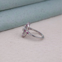 Silver ring with pink gemstone on a light gray surface, art deco navette ring, bezel set CZ ring, openwork vintage ring, fancy pink CZ ring, pink and white CZ ring, navette statement ring