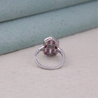 Silver ring with a geometric design on a light gray surface,  art deco cocktail ring, vintage style pink CZ ring, pink stone engagement ring, openwork art deco ring, navette shape ring