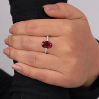 Hand wearing a ring with a red gemstone on a neutral background, Passionate Garnet Oval Bridal Jewelry, Conflict Free Garnet Style Promise Ring