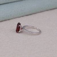 Silver ring with a red gemstone on a light gray surface, Timeless Garnet Inspired Bridal Wedding Ring, Sparkling Red CZ Oval Cut Engagement Jewelry