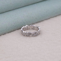 Silver ring with intricate design on a light background, intricate milgrain ring, moissanite stacking band, moissanite eternity ring, floral motif ring, moissanite ring antique finish, 14K gold moissanite band