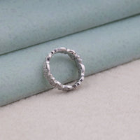 Silver ring on a light blue and beige background,  handmade art deco ring, dainty moissanite eternity band, round cut moissanite band, moissanite wedding jewelry