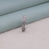 Silver ring with intricate design on a soft fabric background, vintage wedding ring set, moissanite leaf ring, heirloom style eternity ring, romantic moissanite wedding band, elegant moissanite leaf ring, leaf design ring, moissanite band with vintage details