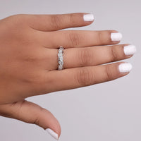 Hand wearing a silver ring with a gray background, vintage style moissanite band, sustainable wedding ring, moissanite anniversary band, milgrain leaf ring, stackable moissanite band, moissanite bridal jewelry, moissanite ring for her, vintage wedding band for bride