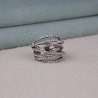 Silver ring with multiple bands on a light gray surface