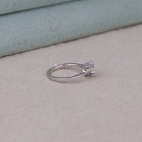 Silver ring with a diamond on a beige surface, Solitaire Heart Moissanite Classic Engagement Wedding Ring, Heart Cut Moissanite Solitaire Ring, Romantic Heart Shaped Engagement Ring, Classic Solitaire Bridal Wedding Ring