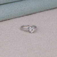 Heart-shaped diamond ring on a light gray surface with a neutral background, 14K Gold Heart Moissanite Promise Ring, Elegant Heart Shape Moissanite Wedding Jewelry, Conflict Free Heart Cut Bridal Ring