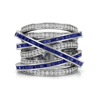 Multi-layered ring with blue gemstones and white stones on a white background