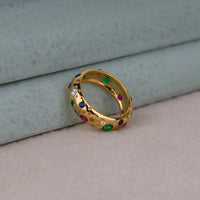 Gold ring with colored gemstones on a light background, Flush Set Star Shape Celestial Band – Colorful CZ Round Gemstone Ring