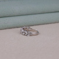 Silver ring with gemstones on a light gray surface
