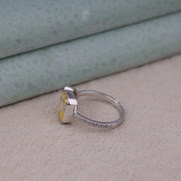 Silver ring with a yellow gemstone on a textured surface, Yellow Emerald Cut and White Moissanite Toi Et Moi Engagement Ring for Women