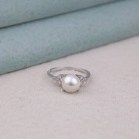 Pearl ring on a light skin tone with a neutral background, Leaf Inspired Moissanite Ring, Nature Inspired Pearl Ring, Minimalist Pearl Ring