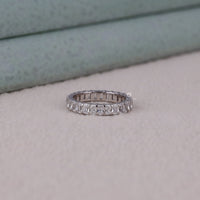 Diamond ring on a light gray surface with a neutral background