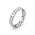 Diamond ring with emerald-cut and baguette-cut diamonds on a white background