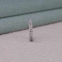 Diamond eternity ring on a neutral background