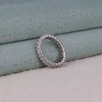 Silver ring with gemstones on a textured surface