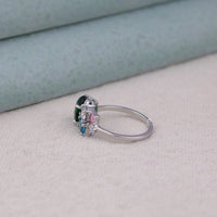 Silver ring with multicolored gemstones on a light gray surface, elegant pastel CZ ring, romantic multi-stone ring, women's fashion ring, dainty gemstone ring