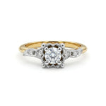 Gold and silver ring with a diamond on a white background