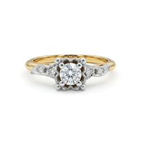 Gold and silver ring with a diamond on a white background