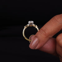 Gold ring with a diamond on a black background