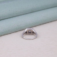 Silver ring with a diamond on a light gray surface, art deco wedding jewelry, old world charm ring, romantic antique motif ring, filigree love ring, classic Edwardian ring, turn of the century ring