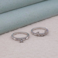 Two silver rings with diamond accents on a soft surface, classic moissanite rings, moissanite couple rings, round vintage wedding rings, art deco moissanite jewelry, minimalist moissanite bridal set, Victorian style moissanite ring