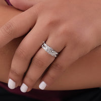 Silver ring with intricate design on a person's finger, Vintage Style Round Moissanite Bridal Ring Set – Engagement Ring & Matching Wedding Band