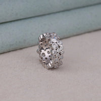 Silver ring with embedded stones on a light gray surface, Glamorous Bubble Wedding Jewelry For Bride, Classic Bezel Set Moissanite Engagement Ring, Eco Friendly Round Moissanite Wedding Band