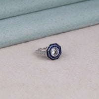 Elegant ring with blue and silver design on a light gray surface, octagonal blue stone ring, regal sapphire ring, fancy CZ engagement ring, bold blue halo ring, art deco blue CZ ring, sapphire anniversary ring