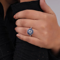 Close-up of a hand wearing a decorative ring with a blue gemstone on a dark background, Fancy CZ Statement Ring, Sapphire Cocktail Ring