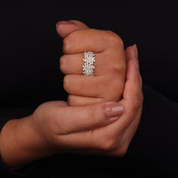 Hand wearing a diamond ring on a black background