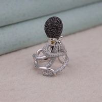 Silver ring with black and clear gemstones on a light background, Bold Ocean Style Statement Ring, Elegant Marine Life Inspired Jewelry, Dainty Octopus Tentacle Engagement Ring