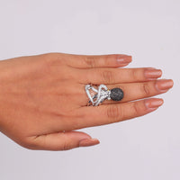 Hand wearing a silver ring with a black gemstone on a light gray background, Ocean Lover’s Octopus Ring, Black and White CZ Animal Statement Jewelry