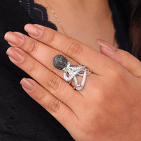 Close-up of a hand wearing two silver rings with intricate designs, “Octopus Statement Ring with Black & White CZ, Unique Ocean-Inspired Adjustable Animal Jewelry”