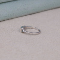 Silver ring with a blue gemstone on a beige surface, Aquamarine Tapered Baguette & CZ Three Stone Promise Ring, Minimalist Engagement Jewelry, Aquamarine Three Stone Wedding Ring