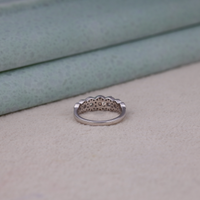 Silver ring with a scalloped edge on a textured surface, Round Moissanite Halo Engagement Ring – Seven Stone White Gold Bridal Ring
