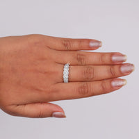 Hand wearing a silver ring on a light gray background, Round Cut Moissanite Engagement Ring – Seven Stone Halo Design Wedding Jewelry