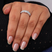 Close-up of a hand wearing a diamond ring with a blurred background, Round Moissanite Seven Stone Halo Engagement Ring – White Gold Wedding Ring for Women